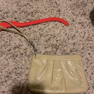 Tan Coach wristlet/ clutch small.